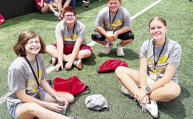Members of Clinton’s Special Olympics team are all smiles while they hang out waiting for their time to play bocce ball during the Special Olympics Summer Games in Stillwater. Pictured, from left, are Raylei Harrel, Kenneth Williams, SJ Adkinson and Lil