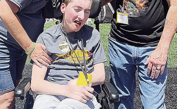 Andrew Schantz, center, enjoys the day at Oklahoma State with his mom, Julia, left, and dad Bobby, right, during the Special Olympics Summer State Games. CDN |Courtesy Photo