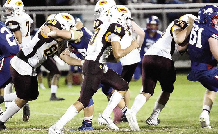 Clinton’s No. 10 JJ Ruiz carries the ball against Chandler Friday while No. 66 Andre Lime and No. 75 Eli Anderson provide blocks for him during the road game. CDN | John Kinsey