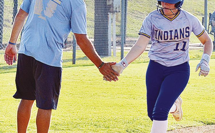 A-B’s Peyton Lambeth, right, shakes hands with Coach Luke Thompson as she rounded third base during her homerun trip around the bases in the Lady Indians’ win over Cheyenne-Reydon Friday at home. CDN | Sam Goodwyn