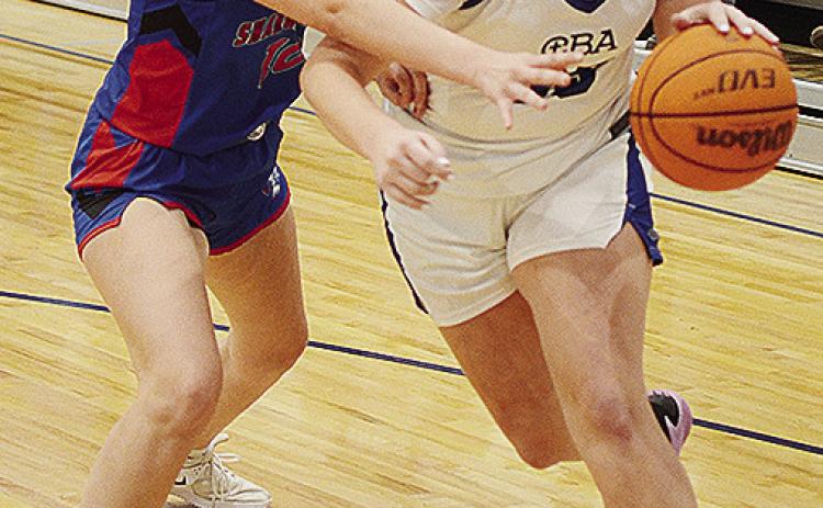 No. 35 Kate Stewart, right, fights to get by her defender during Corn Bible’s win over the Lady Trojans of Sharon-Mutual. CDN | Sam Goodwyn