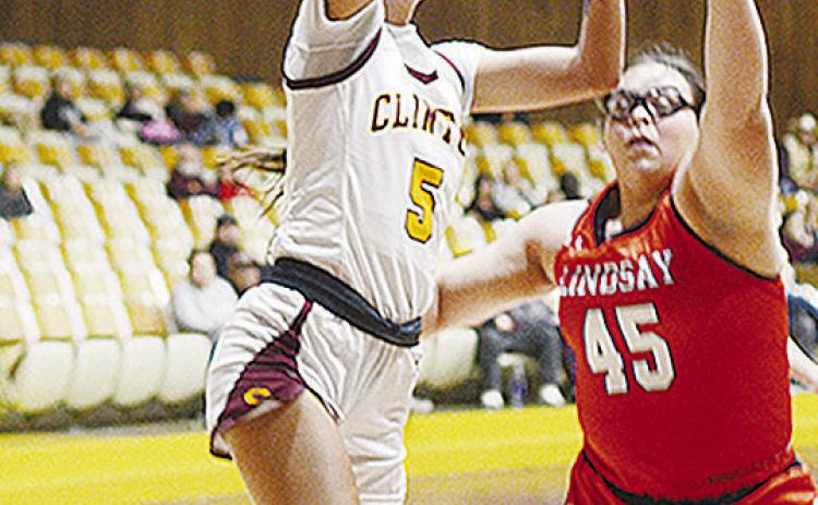 Clinton’s Lillian Lime lays the ball up to the basket over a Lindsay opponent during the Lady Reds’ home opener Saturday against the Leopardettes. CDN | Sam Goodwyn