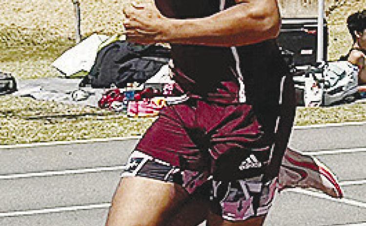 Clinton’s Carrol Hoffman hustles around the track during the Red Tornadoes’ Kay Crenshaw Invitational meet. CDN | Courtesy photo
