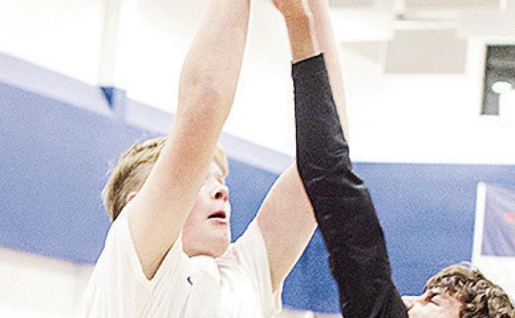 Corn Bible Academy’s Nathan Cooke shoots the ball over the Olustee-Eldorado defender during the Crusaders’ home win over the Diamondbacks. CDN | Sam Goodwyn