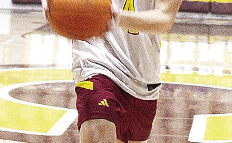 Clinton’s Davien Stanley prepares to pass the ball during the Reds’ home JV game Tuesday against Bethany. CDN | Sam Goodwyn