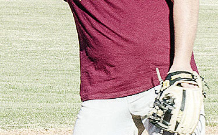 Clinton’s Eli Anderson aims the ball as he prepares to throw it during a Reds’ baseball practice. CDN | Sam Goodwyn