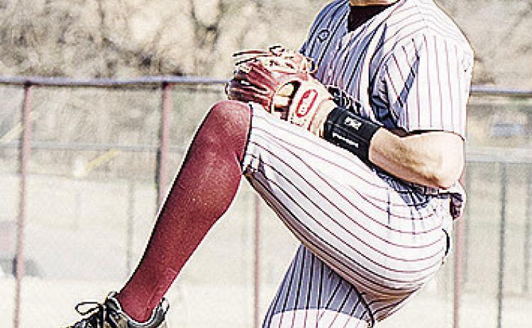 CDN | Sam Goodwyn Clinton’s Easten Powell kicks up his leg as he prepares to pitch against El Reno at home.