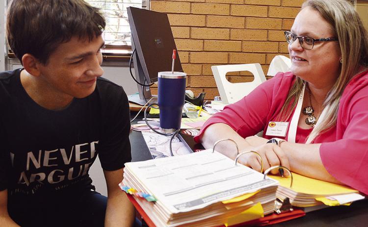 Brycen Farmer, left, and Clinton High School Counselor Casey Perez go over goals for the year in her office Thursday afternoon. CDN | Micah Ashcraft