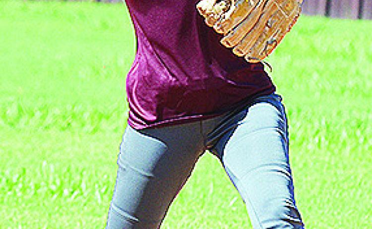 Clinton’s Hadley Meget hurls the ball to first during a drill Tuesday at the softball field. CDN | Sam Goodwyn