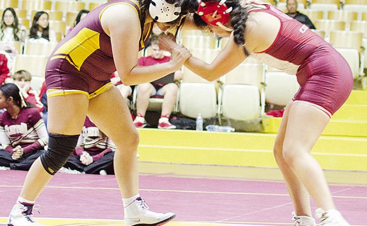 Clinton’s Kassandra Kaline, left, grapples with her opponent from Hinton during the Lady Reds’ home exhibition match with the Lady Comets. CDN | Sam Goodwyn