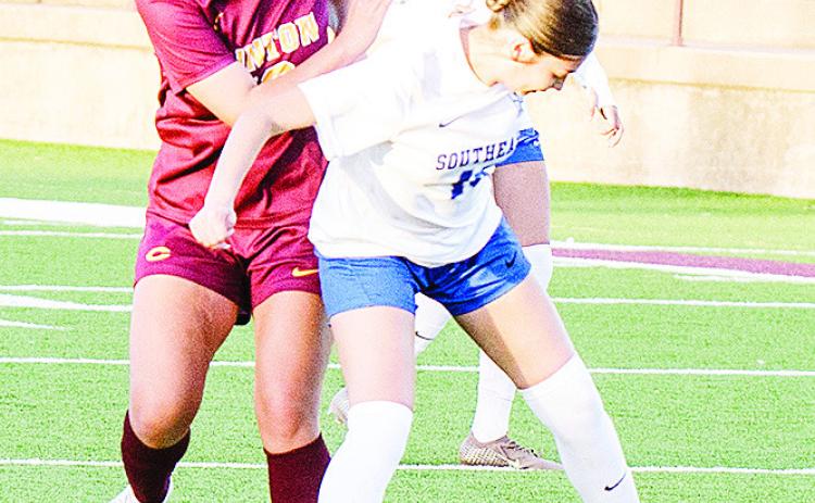 Clinton’s Leila Pete, left, fights through a Southeast defender during the Lady Reds’ home win over the Lady Spartans. CDN | Sam Goodwyn