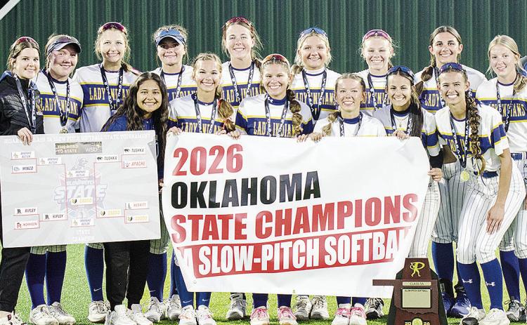 The Arapaho-Butler Lady Indians celebrate winning the 2026 Class 3A Slow-Pitch State Championship Wednesday at FireLake Ball Fields. Pictured from left, in front, are Adrian Randle, Kylin Oakes, Izzie Dewees, Reagan Schoeppach, Maddi Lockhart and Piperrilee Sawatzky; back, Coach Nathan Baker, Channing Cudd, Lauryn McHenry, Keely Baker, Peyton Lambeth, Kelsey Garibay, Lyla Pruitt, Dalaynie Lee, Kylee Brinkley, Presley Littke and Coach Luke Thompson. CDN | Sam Goodwyn