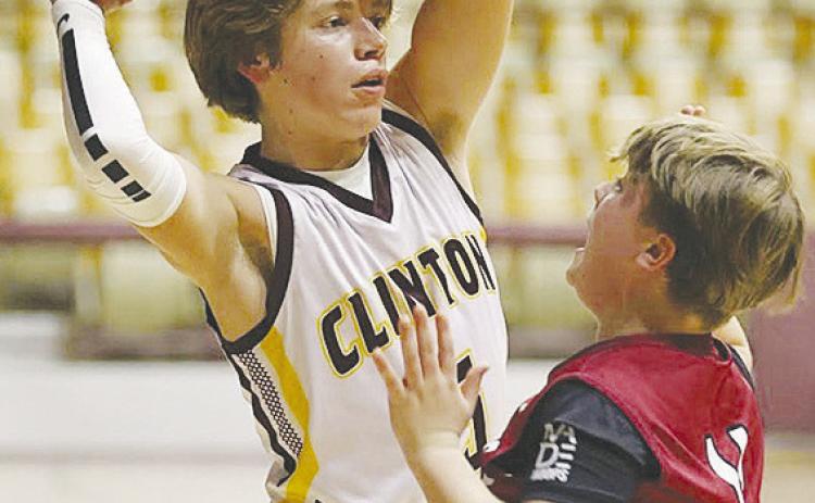 Clinton Middle School’s Braxton Garrison keeps the ball away from a Weatherford defender during the Whirlwinds’ eighthgrade game against the Eagles in the Tornado Dome. CDN |Steve Wheeler