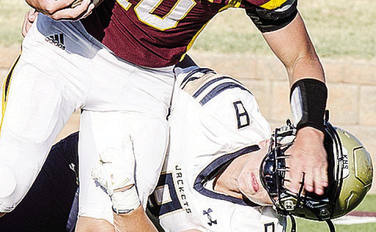 Clinton’s Liam Lofland, left, plows through a Kingfisher defender during the Red Tornadoes’ JV game against the Yellowjackets Monday in the Tornado Bowl. CDN |Sam Goodwyn