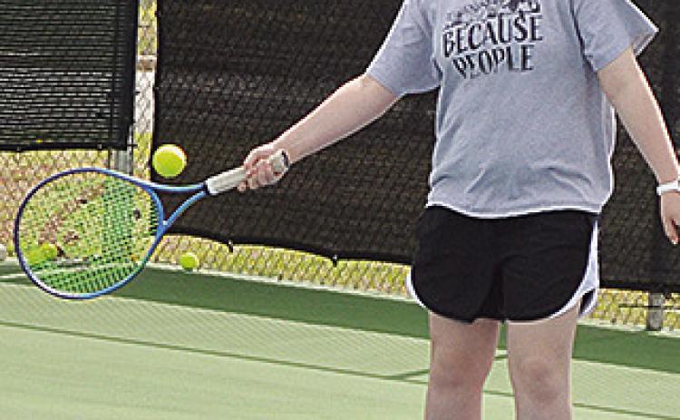 Clinton’s Sami Hammans returns the serve during tennis practice. CDN | Sam Goodwyn