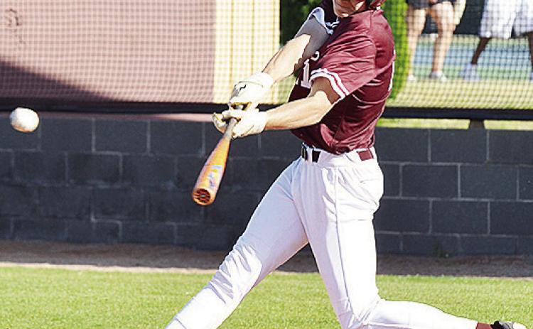 Clinton’s Ayden Crumley launches the ball into the outfield Thursday, as he gets a hit during the Reds’ home game against the Altus Bulldogs. CDN | Sam Goodwyn