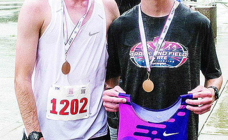 Xadrian Hernandez, left, smiles after winning the 10K portion of the Clinton, Classic Run Saturday and his brother Bentlee, right, smiles after taking first in the 5K portion of the event. CDN | Sam Goodwyn