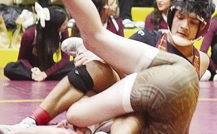 Carrol Hoffman gets Elk City’s Ethan Nelson to flip on his back as he goes to pin him Thursday during the Class 4A District 3 Wrestling Tournament in the Tornado Dome. CDN | Sam Goodwyn
