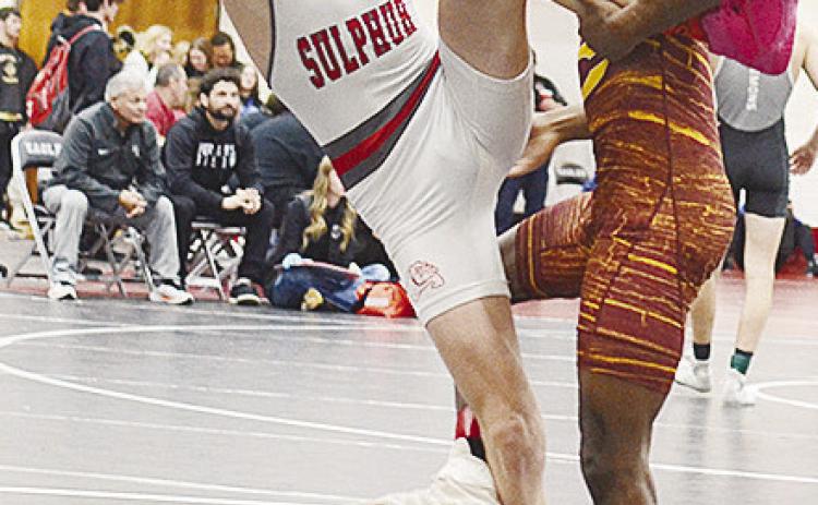 Clinton’s Marquis Martin, right, performs a single-leg takedown of his opponent during the Class 4A Regional Wrestling Tournament in Weatherford Friday. CDN | Sam Goodwyn