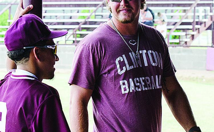 New Clinton baseball coach Cooper Rhoads, right, talks with Azreal Fierros prior to the start of the Reds’ home game against Weatherford this summer. CDN | Sam Goodwyn