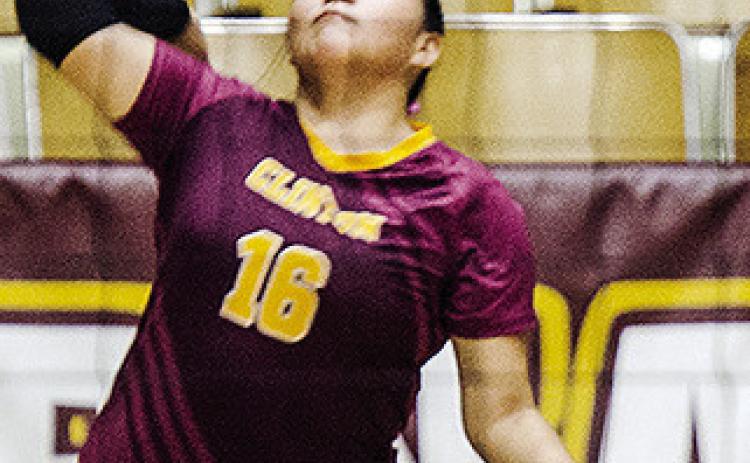 Clinton’s Mallory Burns prepares to serve the ball during the Lady Reds’ home game Monday against The Academy. CDN | Sam Goodwyn