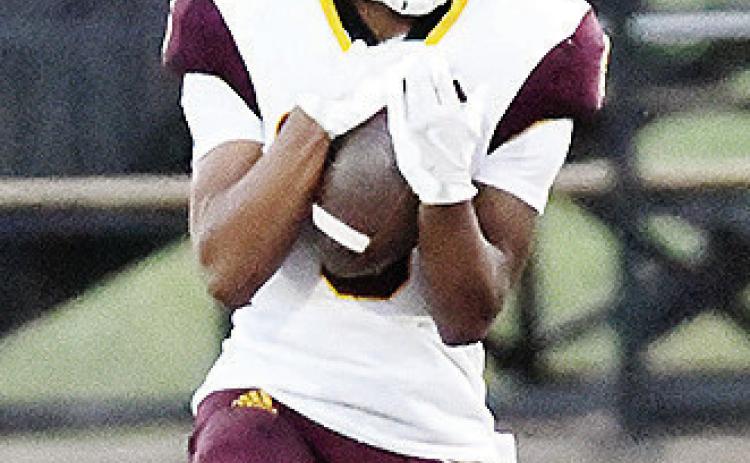 Clinton’s Jesus Gutierrez secures the ball in his arms after receiving the punt during the Red Tornadoes’ road game against Woodward. CDN |John Kinsey