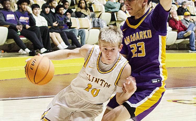 Clinton’s Ryder Adams, left, drives against the Anadarko defender during the Reds’ home game against the Warriors Tuesday in the Tornado Dome. CDN | Sam Goodwyn