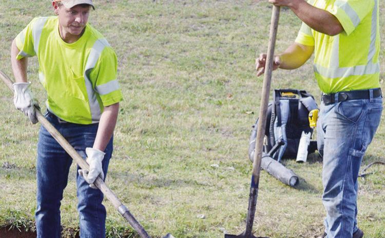 Derek Murray, left, and Alex Fraser work to remove old concrete and asphalt Tuesday on Old Route 66 on the west edge of town. CDN | Christian Jacobsen
