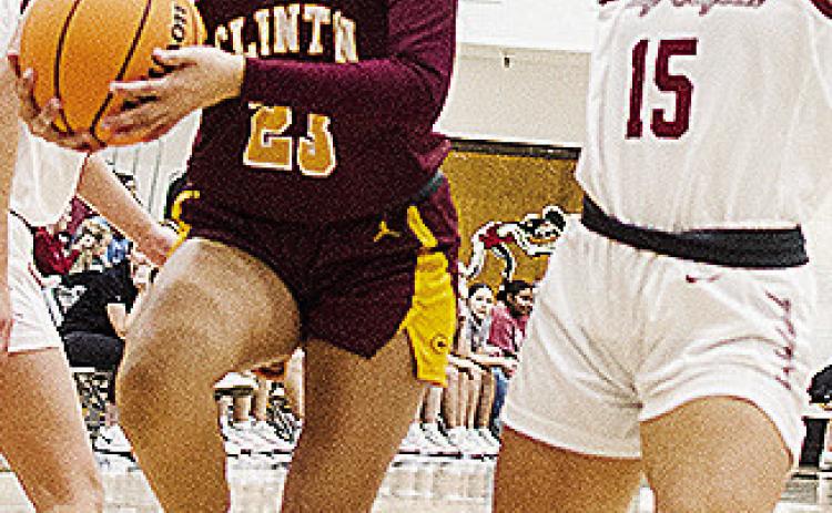 Clinton’s Ella Redshin, left, fights her way to the basket during the Lady Reds’ road game against Weatherford. CDN | Sam Goodwyn