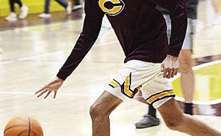 Clinton’s Rufus Whiteman-Ellis dribbles the ball during warmups prior to the Reds recently taking on district foe Elk City in the Tornado Dome. CDN | Sam Goodwyn
