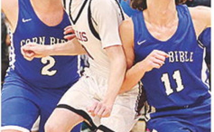 CBA’s Luke Zybach, left, and Braxton Sousa, right, battle with a Hollis player last week during the second round of the CBA Basketball Tournament. CDN |Courtesy Photo