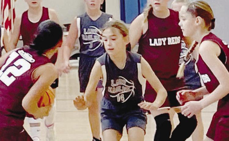 No. 12 Yami Flores looks to make a pass to her fellow teammates