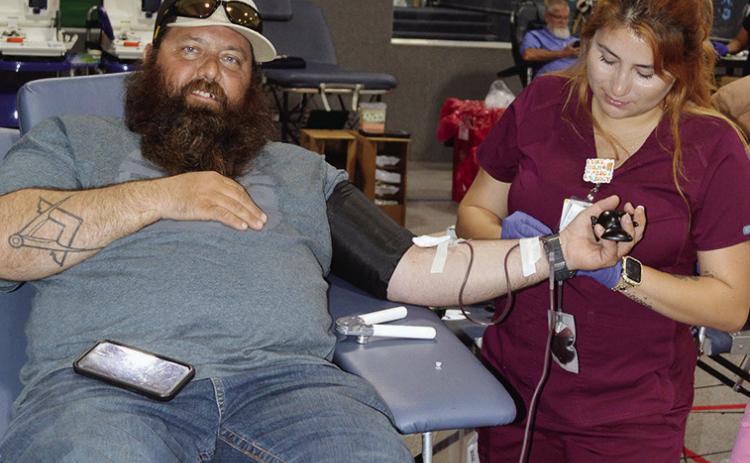 Chad Boggs, left, with the help of phlebotomist Diana Ramirez donates to the blood drive Tuesday at the First Christian Church’s Family Life Center. CDN | Christian Jacobsen
