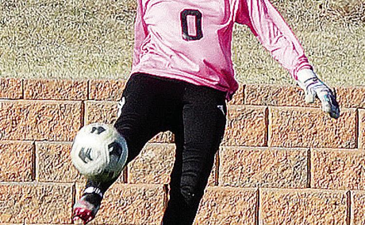 Clinton’s Ciela Burns punts the ball during a game for the Lady Reds last year in the Tornado Bowl. CDN | Sam Goodwyn