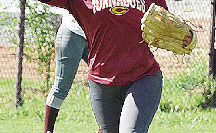 Clinton’s Reece Giblet throws the ball across the field during a preseason practice at the softball field. CDN | Sam Goodwyn