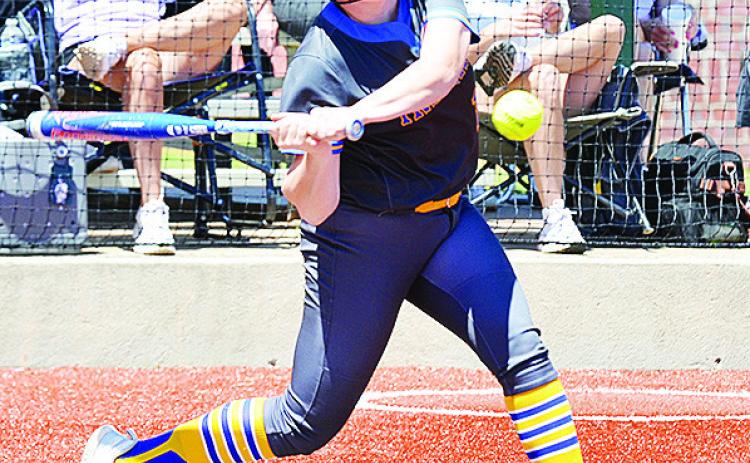 No. 13 Lauryn McHenry focuses on the ball as she prepares to swing at it during the regional tournament in Elk City during the spring season. CDN | Sam Goodwyn