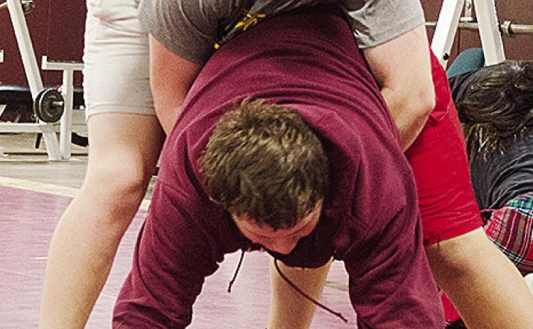 Clinton’s Layne Spitz, top, wrestles with Isaiah Dustman during practice in the wrestling room Wednesday. CDN | Sam Goodwyn