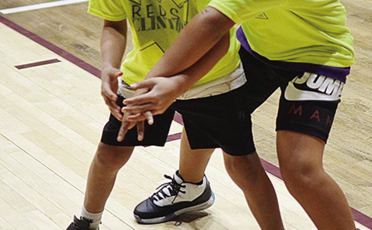 Kai Jefferson, right, knocks the ball out of Charlie Moss’ hands during warm-ups prior to the second-grade boys’ championship game for Southwest at the Tornado Bowl. CDN | Sam Goodwyn