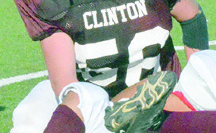 Clinton seventh-grader Rayden Walker finishes a tackle during a recent middle school football game.