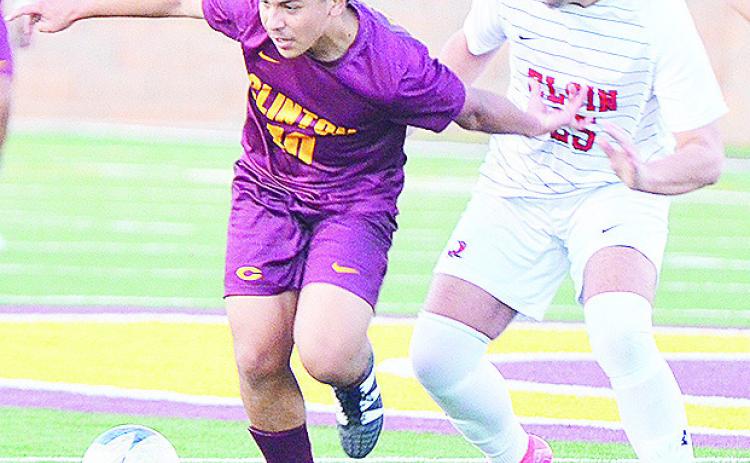 Clinton’s Lino Martinez fights off an Elgin defender for control of the ball during the Red Tornadoes’ win over the Owls in the Tornado Bowl. CDN | Sam Goodwyn