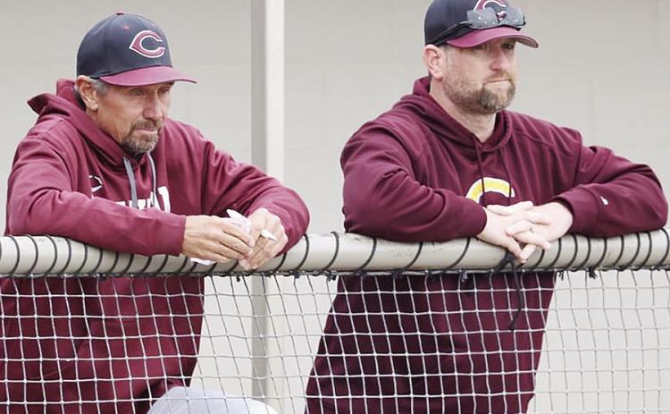 Clinton’s longtime baseball coach Kelly Gaunt, left, and assistant coach Jeff King watch during a baseball game. CDN | Steve Wheeler