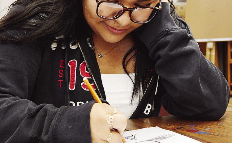 CHS sophomore Analy Venegas sketches a still life of a mug during her art class at Clinton High School. CDN | Micah Ashcraft