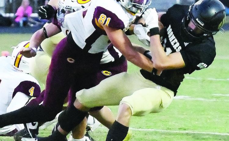 Clinton’s Ben Daugherty levels the Woodward ballcarrier during the Red Tornadoes’ win over the Boomers Thursday in Woodward. CDN | John Kinsey