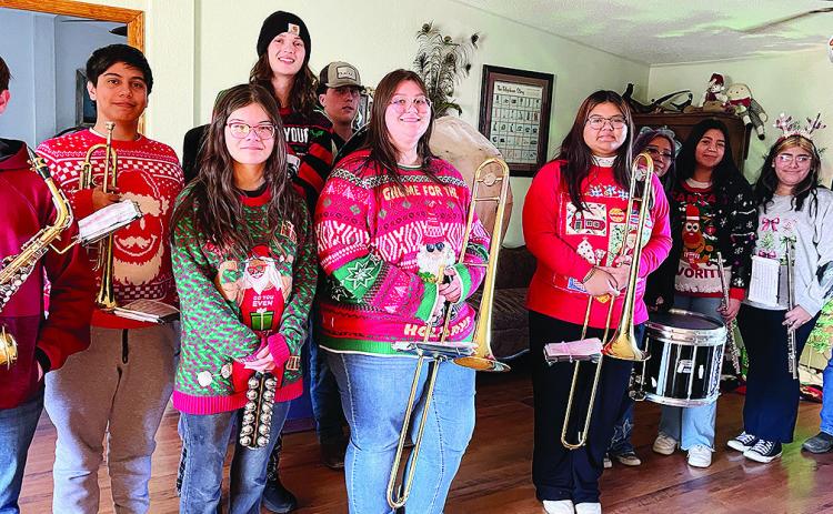 CHS band members playing songs included, from left, Charles Terrell, Jesus Bonilla, Hazel Hoffman, Jackson McCullough, Corbin Weaver, Abigail Williams, Belicia Gamon, Jules Harrison, Karely Aguilar Guzman, Ashley Garcia and homeowner Mike Mapel. Not pictu