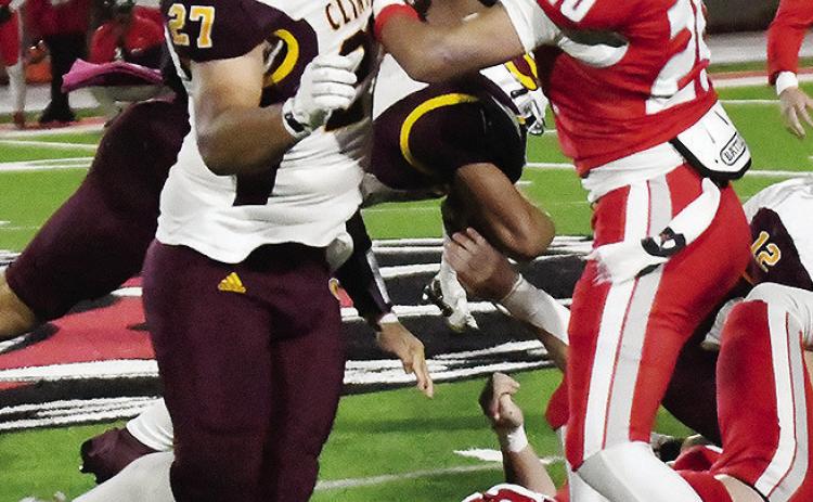 Clinton’s Alex Amaya, left, blocks a Cache defender during the Red Tornadoes’ win Thursday over the Bulldogs. CDN | John Kinsey