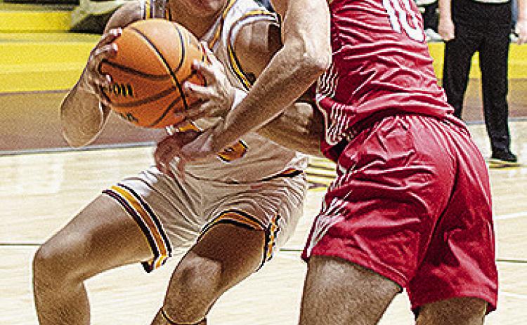Clinton’s Easten Powell, left, drives through an Elgin defender during the Reds’ home win Tuesday against the Owls. CDN | Sam Goodwyn