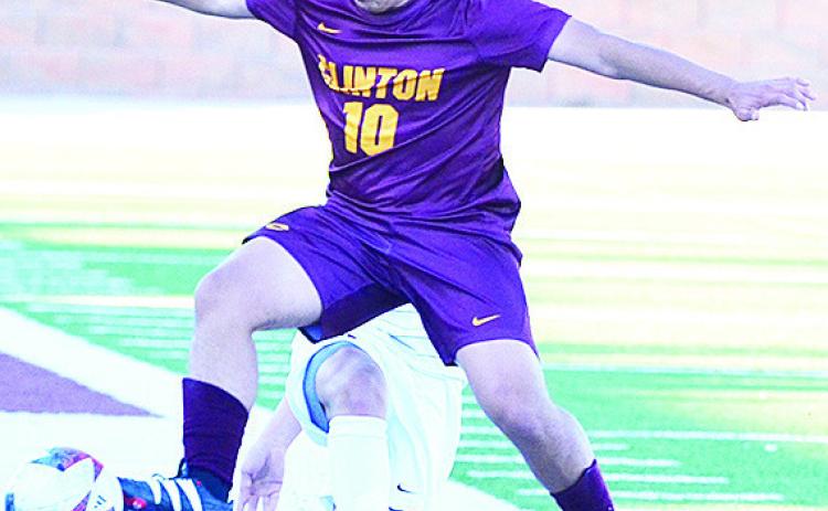 Clinton’s Lino Martinez gets to the ball before the Elgin player during the Reds’ home game against the Owls. CDN | Sam Goodwyn