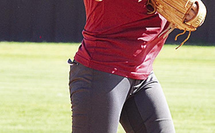 Clinton’s Reece Giblet throws the ball during a softball practice. CDN | Sam Goodwyn