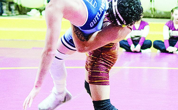 Clinton’s Tristan Cardenas, right, takes his opponent to the mat during the Reds’ match against Marlow Thursday in the Tornado dome. CDN | Sam Goodwyn