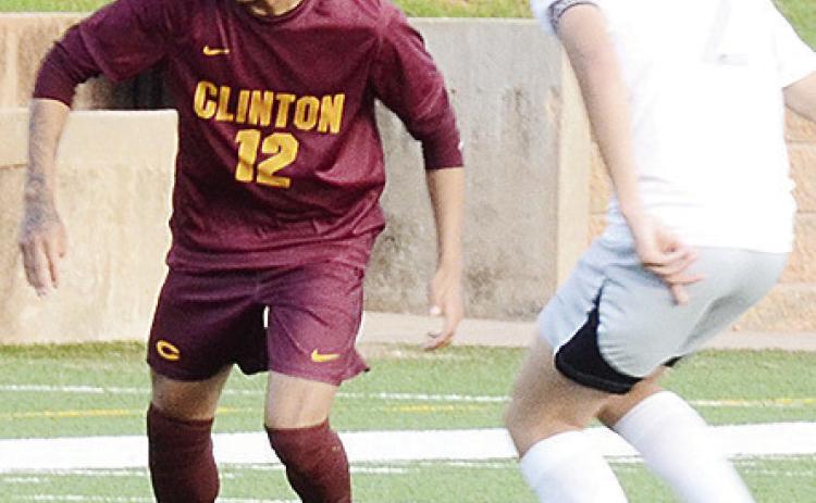 Clinton’s Austin Reynaga, left, tries to get the ball around the Chickasha defender during the Red Tornadoes’ first round playoff win over the Fighting Chicks Monday at home. CDN | Sam Goodwyn
